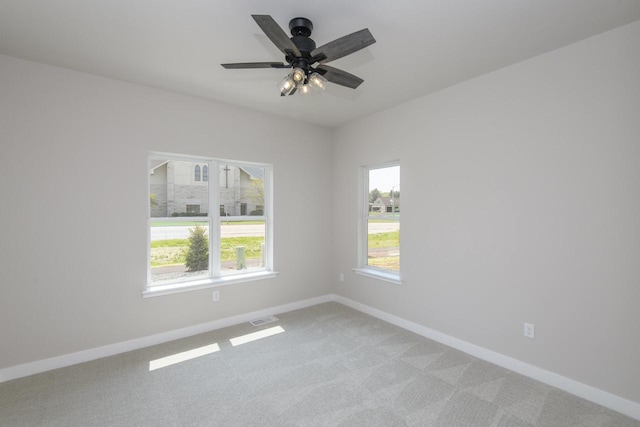 20840 Gray St, Lannon, WI 53046 - empty room with baseboards, healthy amount of natural light, light colored carpet, and ceiling fan
