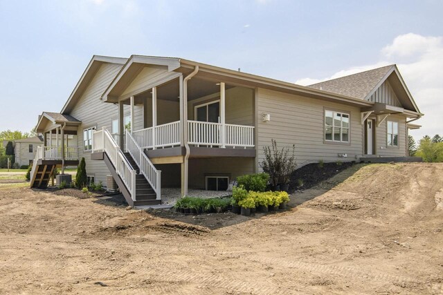 20840 Gray St, Lannon, WI 53046 - view of side of home featuring stairs, central AC, and a porch