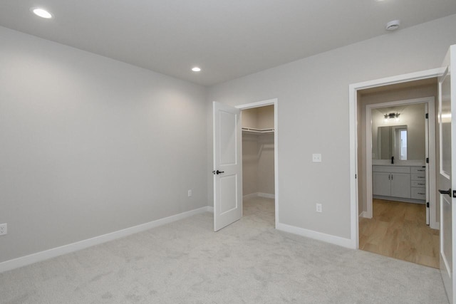 20840 Gray St, Lannon, WI 53046 - unfurnished bedroom with light carpet, baseboards, recessed lighting, a spacious closet, and a closet