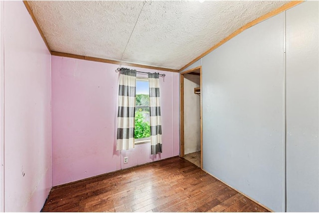 2077A 250th Ave Unit N, Luck, WI 54853 - empty room with a textured ceiling and hardwood / wood-style flooring