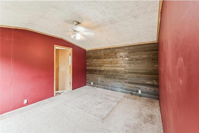 2077A 250th Ave Unit N, Luck, WI 54853 - unfurnished room with wooden walls, carpet flooring, lofted ceiling, ceiling fan, and a textured ceiling