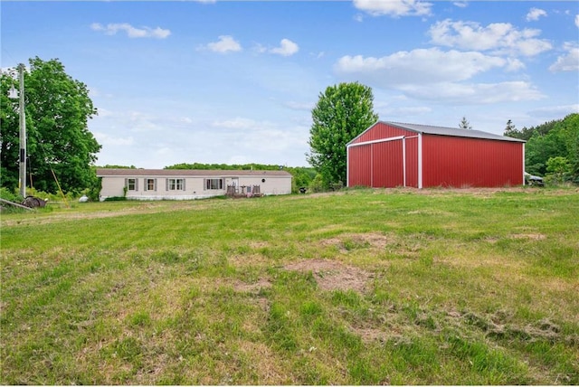2077A 250th Ave Unit N, Luck, WI 54853 - view of grassy yard featuring a pole building and an outdoor structure