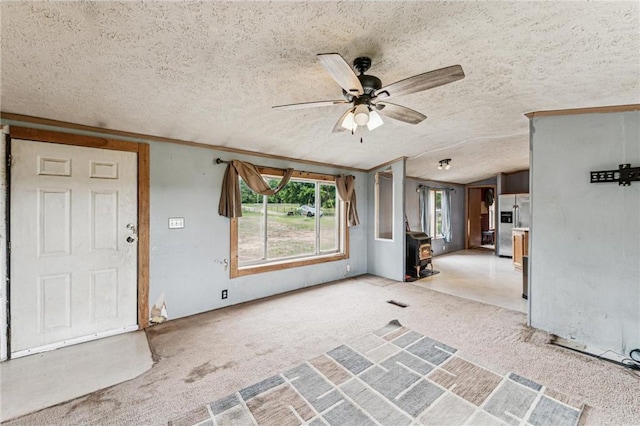 2077A 250th Ave Unit N, Luck, WI 54853 - foyer entrance with a ceiling fan, carpet flooring, a textured ceiling, lofted ceiling, and a wood stove