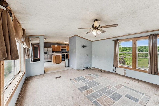 2077A 250th Ave Unit N, Luck, WI 54853 - unfurnished living room featuring light colored carpet, a ceiling fan, a textured ceiling, and crown molding