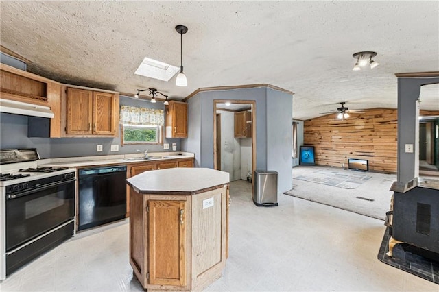 2077A 250th Ave Unit N, Luck, WI 54853 - kitchen with dishwasher, gas range, wood walls, a ceiling fan, and under cabinet range hood