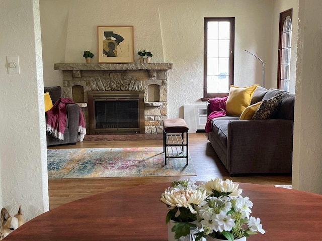 620 W Rock Pl, Glendale, WI 53209 - living room with a textured wall, wood finished floors, and a fireplace