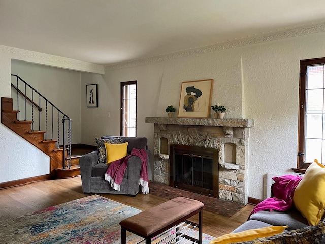 620 W Rock Pl, Glendale, WI 53209 - living room featuring wood finished floors, a fireplace, baseboards, stairs, and a textured wall