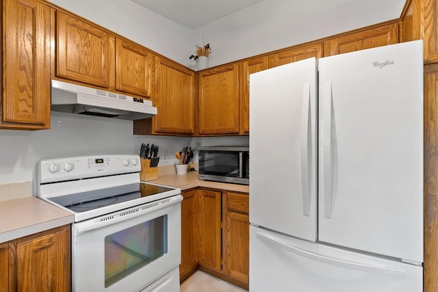 1330 Pinehurst Ln, Neenah, WI 54956 - kitchen with white appliances, under cabinet range hood, light countertops, and brown cabinetry