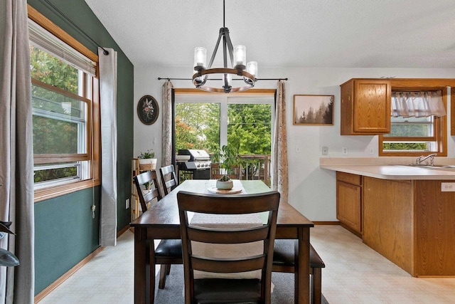 1330 Pinehurst Ln, Neenah, WI 54956 - dining space with a chandelier, a textured ceiling, baseboards, and light floors
