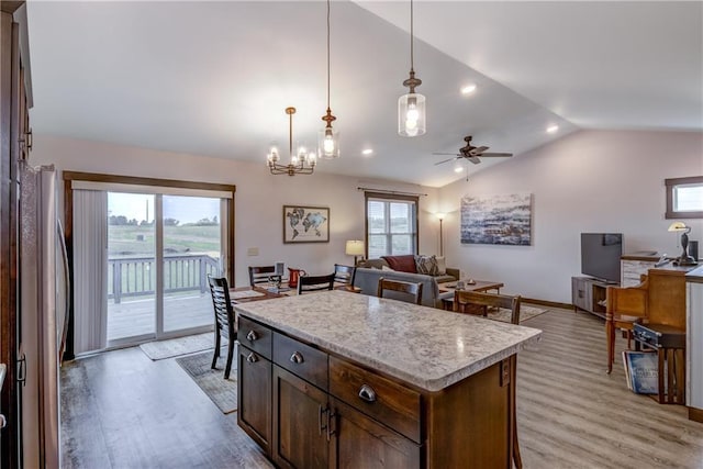 16437 56th Ave, Chippewa Falls, WI 54729 - kitchen featuring vaulted ceiling, freestanding refrigerator, light wood-style flooring, pendant lighting, and light countertops