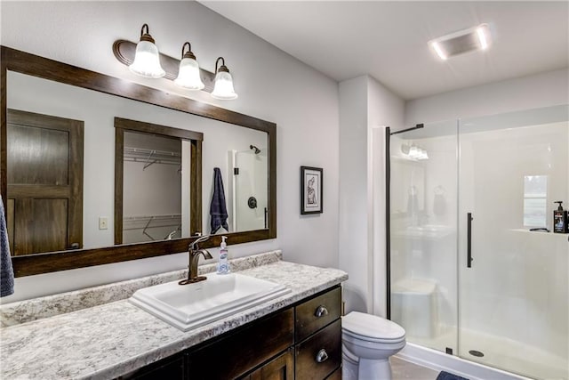 16437 56th Ave, Chippewa Falls, WI 54729 - bathroom featuring a stall shower, vanity, toilet, and a spacious closet