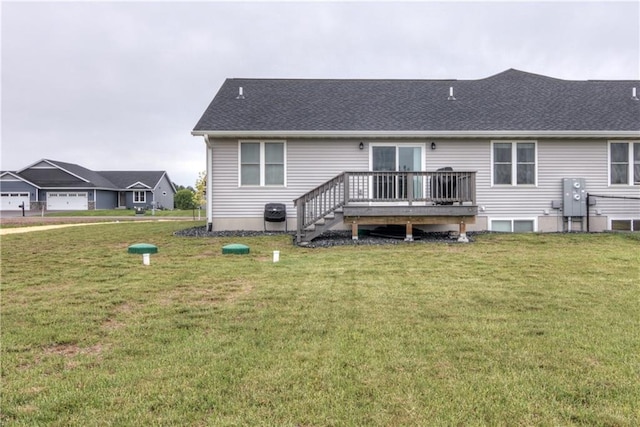 16437 56th Ave, Chippewa Falls, WI 54729 - rear view of property featuring a wooden deck, a yard, and a shingled roof
