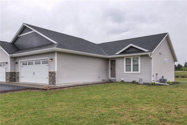 16437 56th Ave, Chippewa Falls, WI 54729 - view of front facade with a garage, a front yard, central AC unit, a shingled roof, and driveway