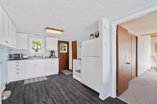 440 N Hudson Ave, Sturgeon Bay, WI 54235 - kitchen with white appliances, a sink, white cabinets, dark wood-style floors, and dark countertops