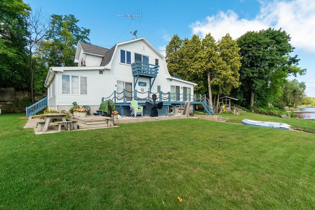 440 N Hudson Ave, Sturgeon Bay, WI 54235 - back of property featuring stairs, a balcony, a deck, and a yard