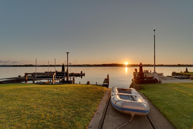 440 N Hudson Ave, Sturgeon Bay, WI 54235 - dock with boat lift, a water view, and a lawn