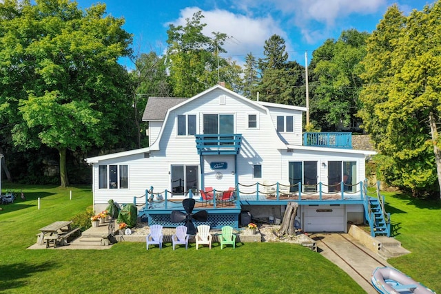 440 N Hudson Ave, Sturgeon Bay, WI 54235 - back of property featuring a balcony, an attached garage, a yard, a gambrel roof, and a deck