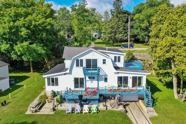 440 N Hudson Ave, Sturgeon Bay, WI 54235 - back of property with a balcony, a wooden deck, a lawn, and stairs