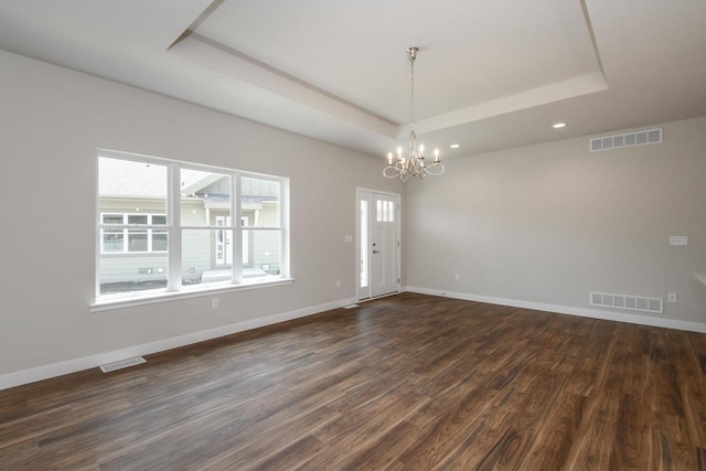 20880 Gray St, Lannon, WI 53046 - spare room with a tray ceiling, a chandelier, dark wood-style floors, baseboards, and recessed lighting