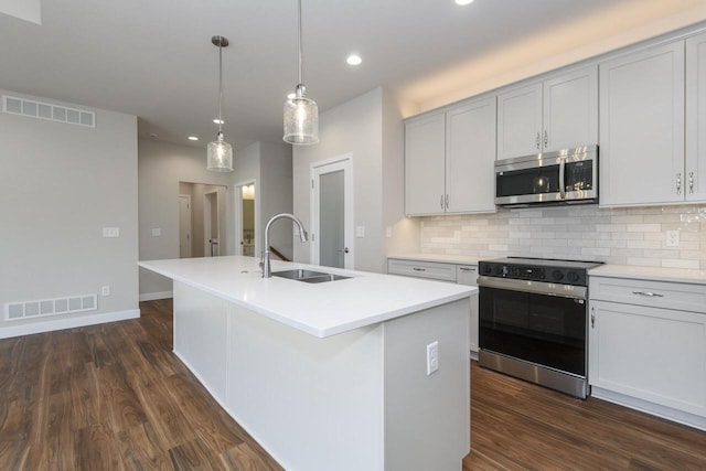 20880 Gray St, Lannon, WI 53046 - kitchen featuring stainless steel microwave, range with electric cooktop, a sink, recessed lighting, and decorative backsplash
