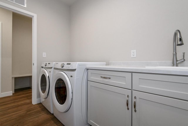 20880 Gray St, Lannon, WI 53046 - washroom with cabinet space, independent washer and dryer, dark wood-type flooring, and baseboards