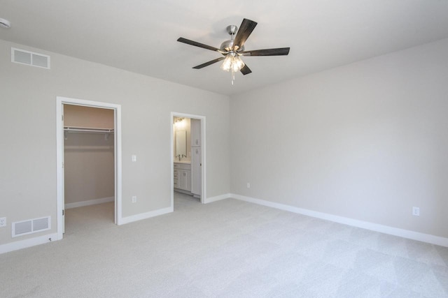20880 Gray St, Lannon, WI 53046 - unfurnished bedroom with light colored carpet, a walk in closet, baseboards, and a closet