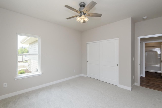 20880 Gray St, Lannon, WI 53046 - unfurnished bedroom with light carpet, baseboards, a closet, and ceiling fan
