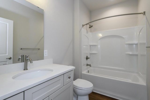 20880 Gray St, Lannon, WI 53046 - bathroom with vanity, toilet, shower / washtub combination, and wood finished floors