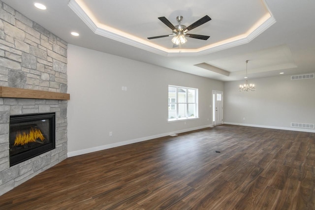 20880 Gray St, Lannon, WI 53046 - unfurnished living room with a raised ceiling, a fireplace, a chandelier, crown molding, and a ceiling fan