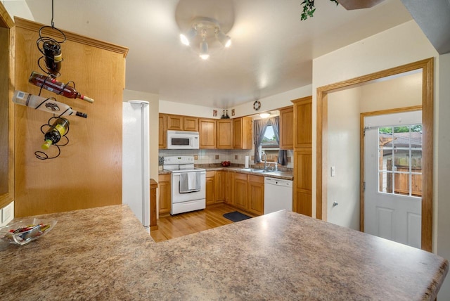 17120 W Fullerton Ave, New Berlin, WI 53151 - kitchen featuring white appliances, a sink, light wood-type flooring, and plenty of natural light