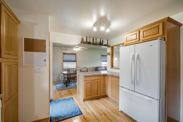 17120 W Fullerton Ave, New Berlin, WI 53151 - kitchen featuring freestanding refrigerator, a peninsula, light wood finished floors, ceiling fan, and light countertops