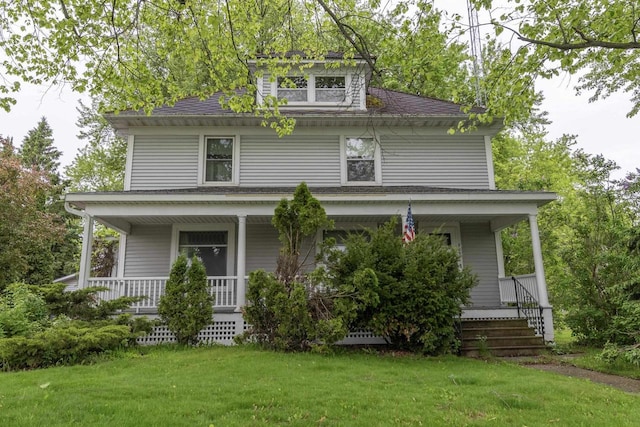 305 N 1st St, Colby, WI 54421 - view of front of home with covered porch, a front lawn, and roof with shingles