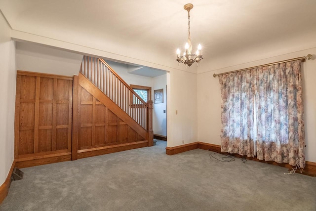305 N 1st St, Colby, WI 54421 - empty room featuring stairway, a chandelier, carpet flooring, and baseboards