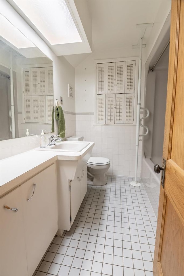 305 N 1st St, Colby, WI 54421 - bathroom featuring vanity, tile patterned floors, toilet, tile walls, and shower / washtub combination
