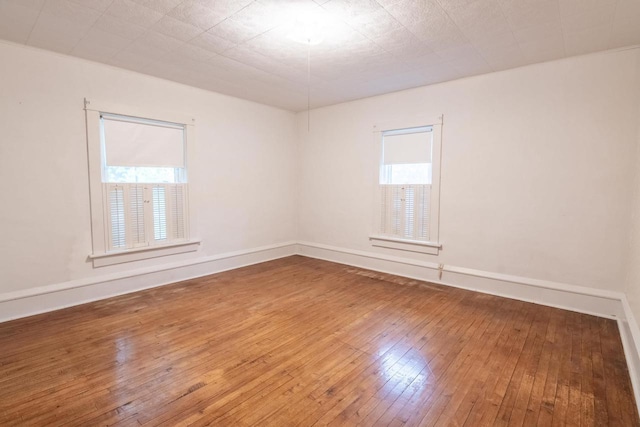 305 N 1st St, Colby, WI 54421 - empty room featuring plenty of natural light, hardwood / wood-style floors, and baseboards