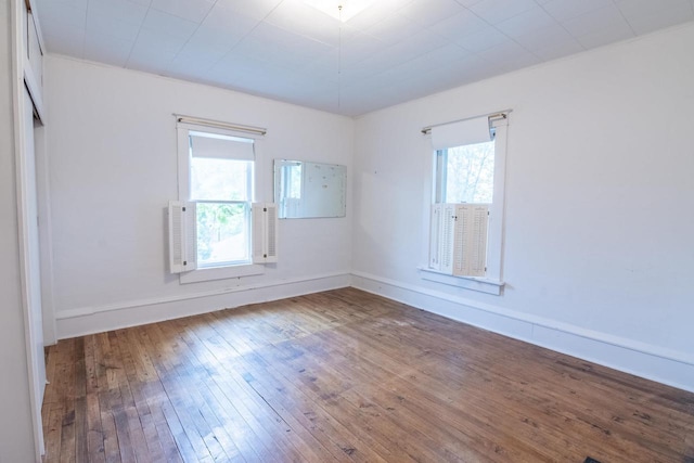 305 N 1st St, Colby, WI 54421 - unfurnished room featuring plenty of natural light, wood-type flooring, and baseboards