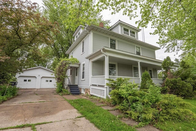 305 N 1st St, Colby, WI 54421 - view of front of home featuring an outbuilding, a detached garage, a porch, and a chimney