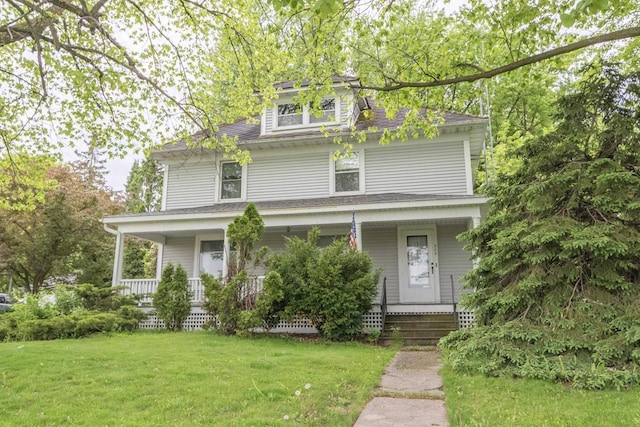 305 N 1st St, Colby, WI 54421 - traditional style home featuring a porch, a front yard, and roof with shingles