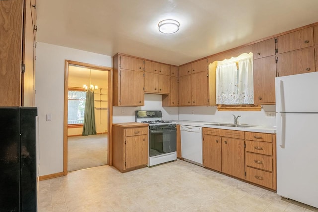 305 N 1st St, Colby, WI 54421 - kitchen with white appliances, a sink, light countertops, and a chandelier