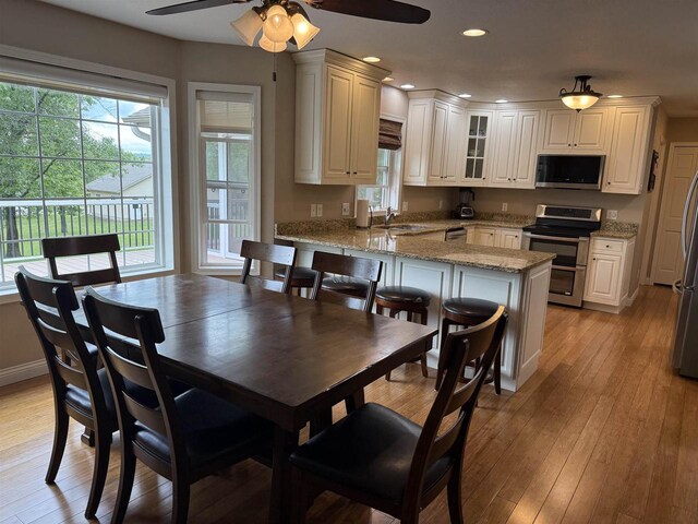 121 Doc Mac Dr, Boscobel, WI 53805 - dining room featuring a ceiling fan, light wood-style flooring, recessed lighting, and baseboards