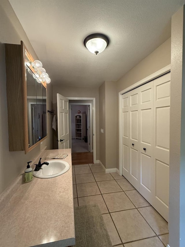 121 Doc Mac Dr, Boscobel, WI 53805 - bathroom featuring vanity, tile patterned flooring, a textured ceiling, and baseboards