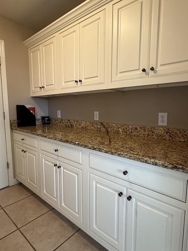121 Doc Mac Dr, Boscobel, WI 53805 - kitchen featuring light tile patterned floors, dark stone countertops, and white cabinetry