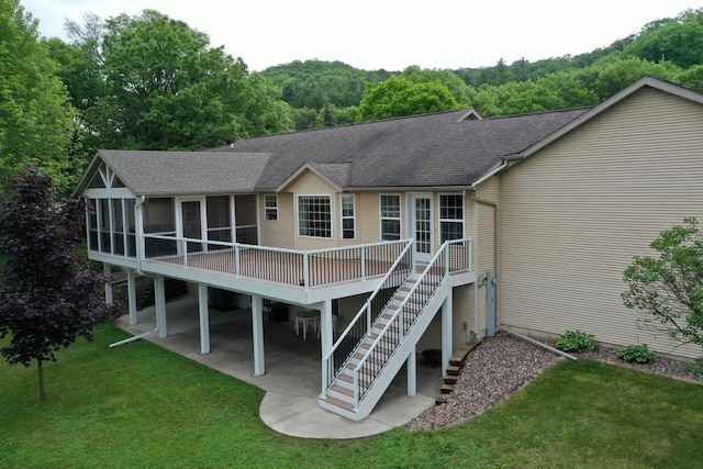 121 Doc Mac Dr, Boscobel, WI 53805 - rear view of property with a shingled roof, a lawn, a sunroom, a patio, and a deck