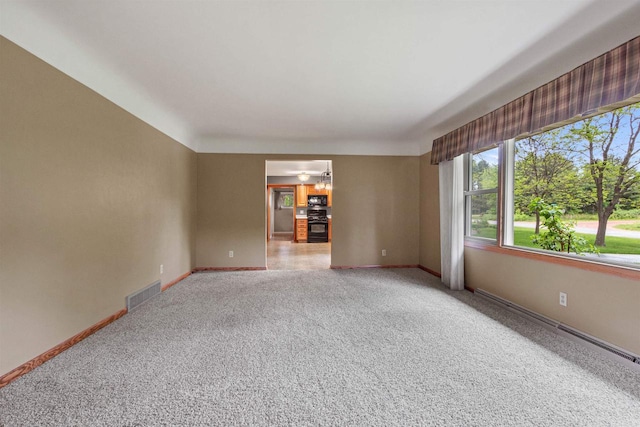 3594 Sunset Dr N, Stevens Point, WI 54482 - empty room featuring light carpet, baseboards, and a baseboard heating unit