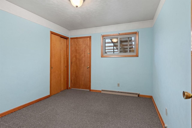 3594 Sunset Dr N, Stevens Point, WI 54482 - unfurnished bedroom featuring baseboard heating, baseboards, carpet, and a closet