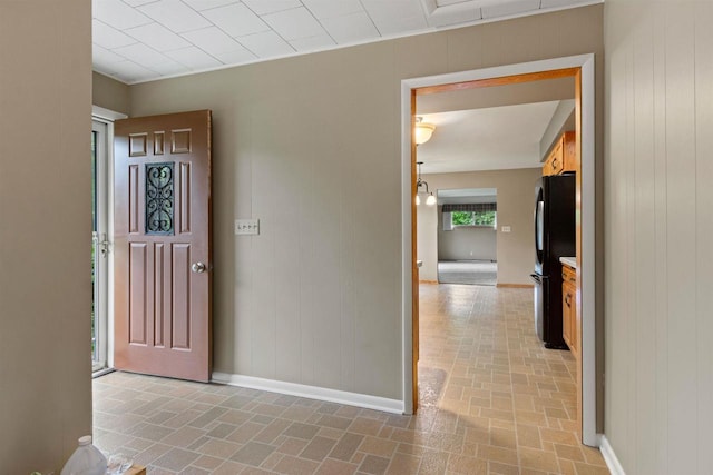 3594 Sunset Dr N, Stevens Point, WI 54482 - entrance foyer with brick patterned floors, baseboards, and wooden walls
