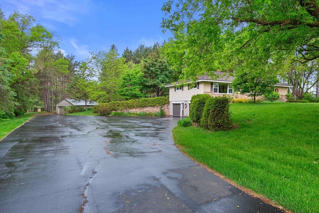 3594 Sunset Dr N, Stevens Point, WI 54482 - view of front of property featuring driveway, a garage, and a front lawn