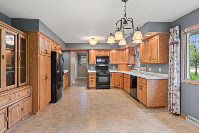 3594 Sunset Dr N, Stevens Point, WI 54482 - kitchen featuring black appliances, baseboards, a chandelier, light countertops, and brick patterned flooring