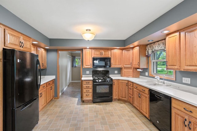 3594 Sunset Dr N, Stevens Point, WI 54482 - kitchen featuring black appliances, a sink, light countertops, baseboards, and brick patterned flooring