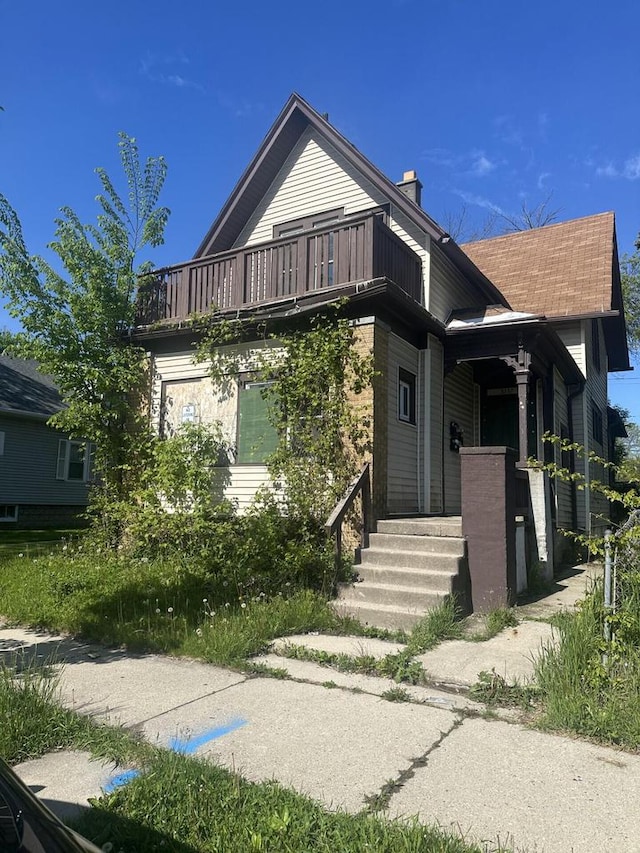 3237 N 10th St, Milwaukee, WI 53206 - view of front facade with a balcony and a chimney